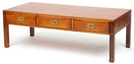 Military interest yew wood campaign style coffee table with three frieze drawers and brass mounts,