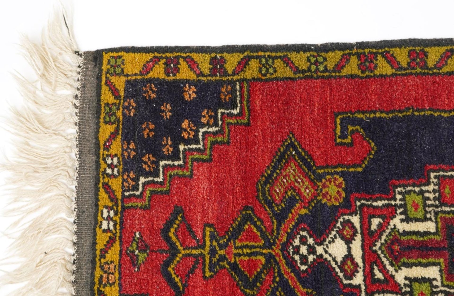Rectangular Persian red and blue ground rug having an allover repeat floral design, 120cm x 53.5cm - Image 2 of 3