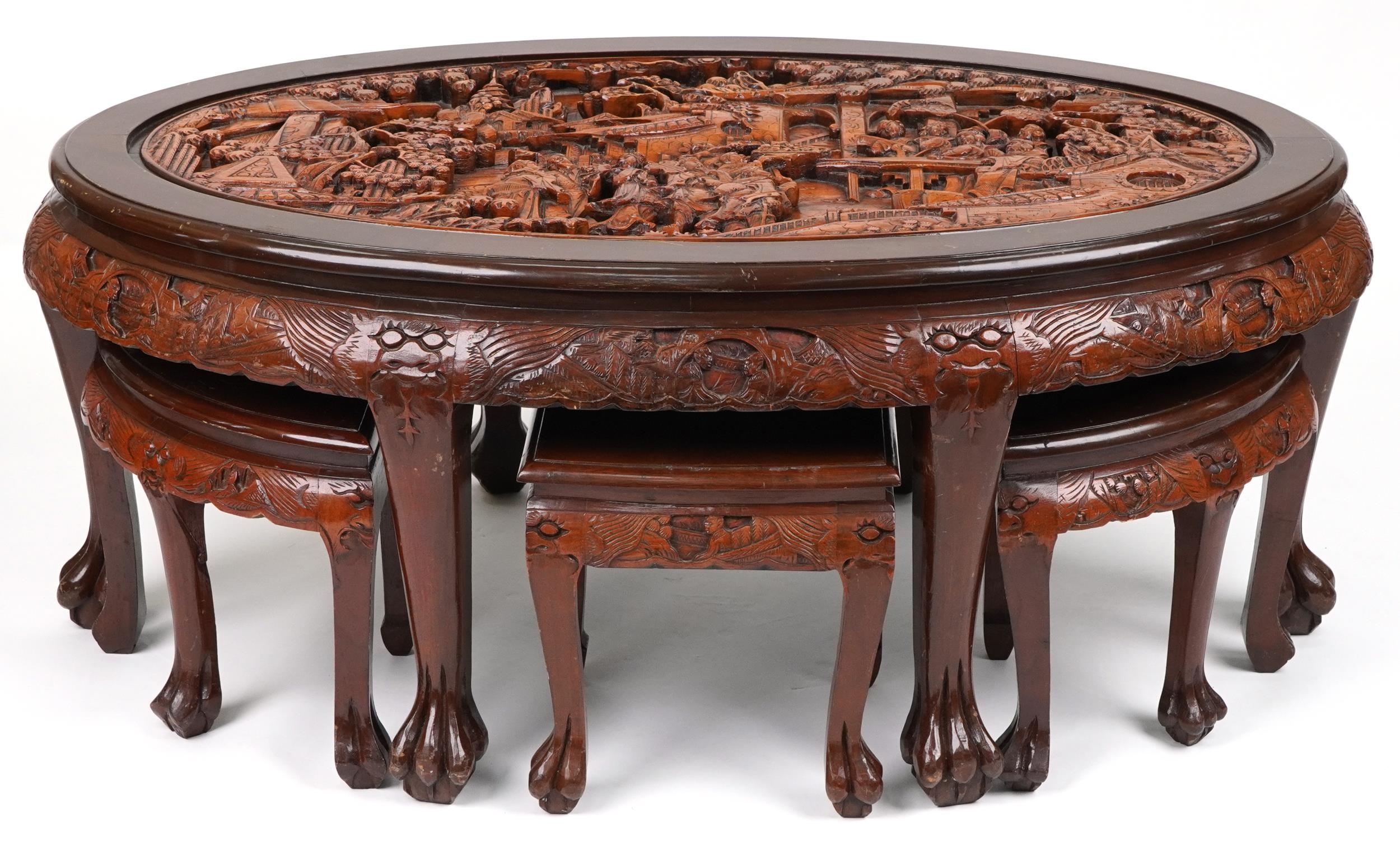 Nest of seven Chinese camphor wood occasional tables comprising an oval coffee table housing six