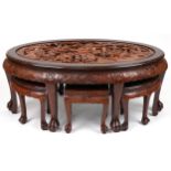 Nest of seven Chinese camphor wood occasional tables comprising an oval coffee table housing six