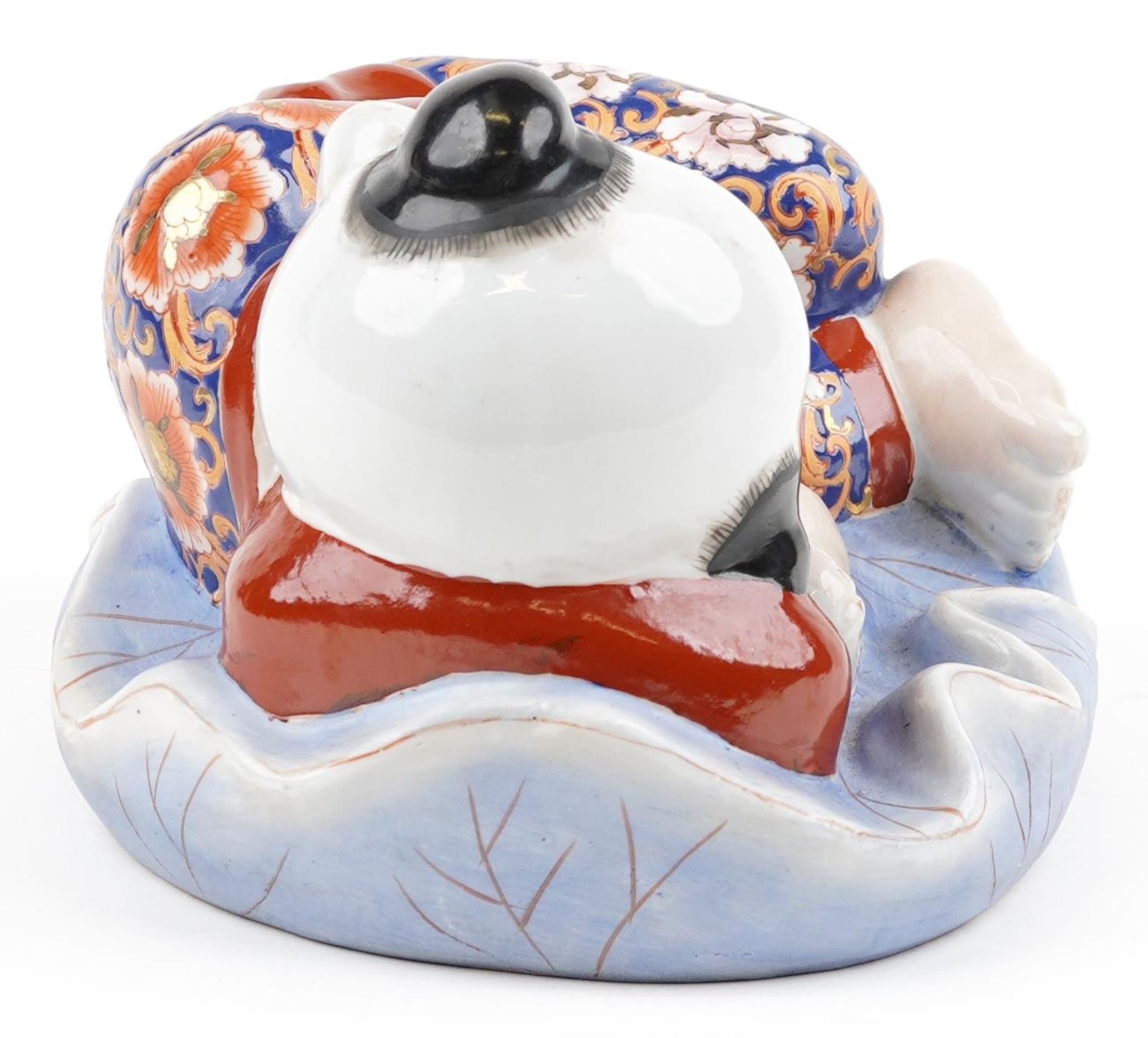 Chinese porcelain figure of a sleeping boy hand painted in the Imari palette, 24cm wide - Image 5 of 9