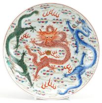 Chinese porcelain shallow dish hand painted in the famille rose palette with dragons chasing the