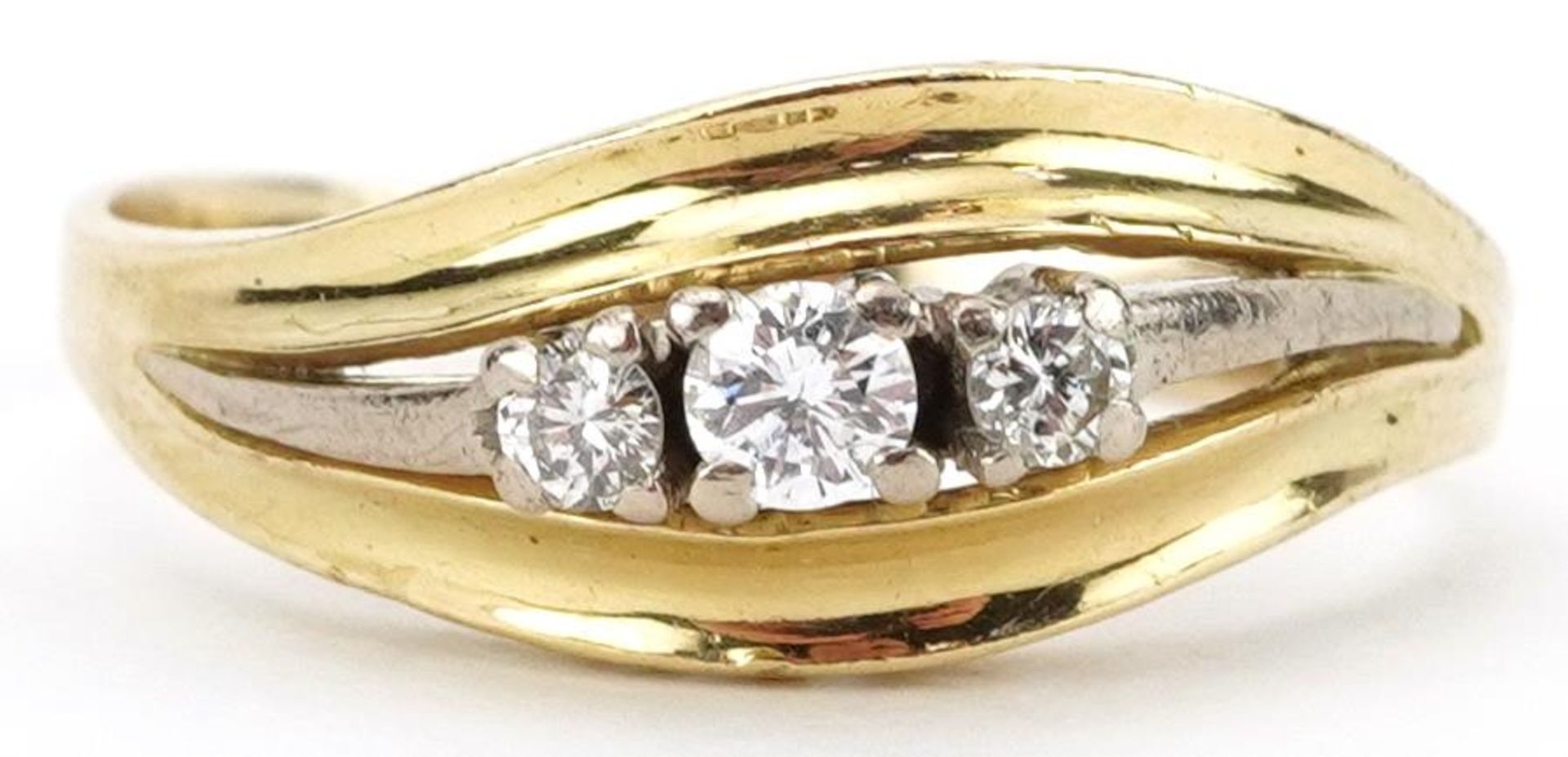 Two tone gold diamond three stone ring, indistinct mark to the band, the central diamond