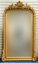 Large ornate gilt framed wall mirror having bevelled glass mounted with flowers and foliage, 220cm x