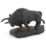 Black painted cast iron sculpture of a raging bull, 30.5cm in length