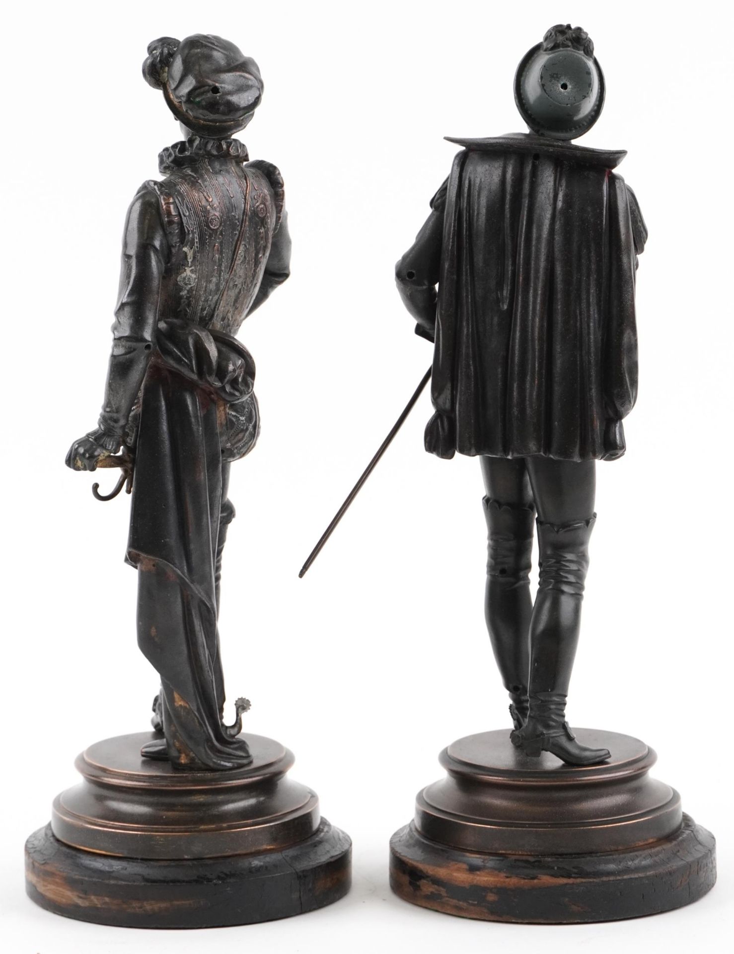 Pair of Victorian patinated spelter figures in 17th century dress raised on circular ebonised wooden - Image 2 of 3