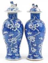 Pair of Chinese blue and white porcelain baluster vases with unassociated covers, each hand
