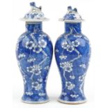 Pair of Chinese blue and white porcelain baluster vases with unassociated covers, each hand