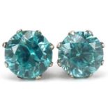 Pair of white metal blue topaz stud earrings, each approximately 6.70mm in diameter, total 2.0g