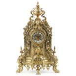 Large 19th century style classical brass mantle clock with urn finial and mask having circular