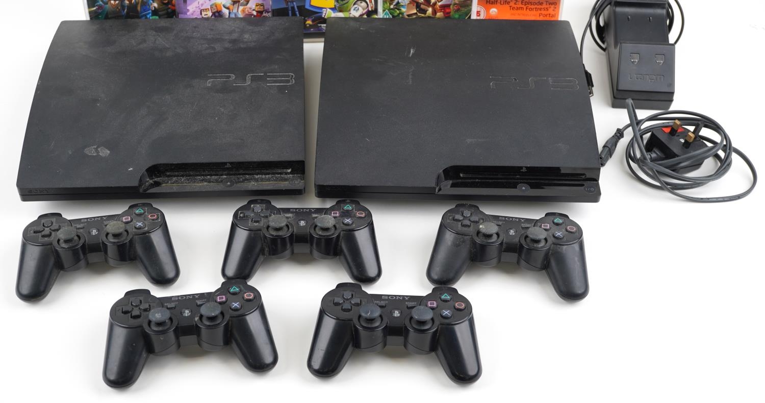 Two Sony PlayStation 3 games consoles with five controllers, docking station and games including Tom - Image 3 of 3