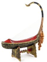 Large Burmese black and red lacquered Saung-gauk harp on stand, each gilt decorated in low relief