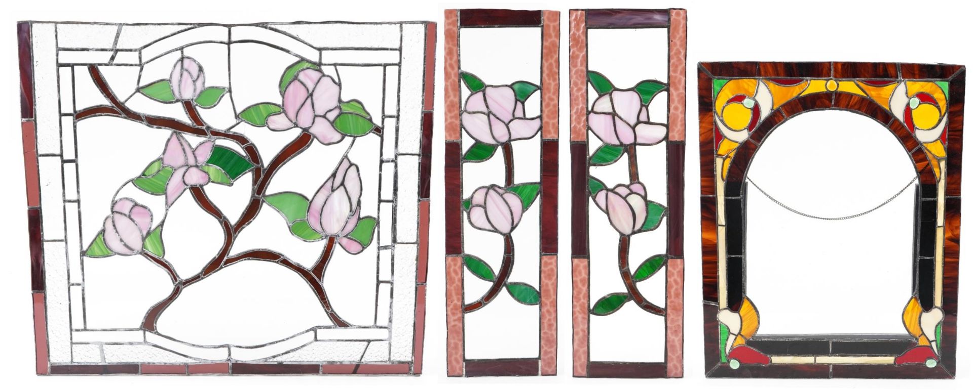 Four leaded stained glass window panels including a pair, each decorated with flowers, the largest