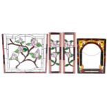 Four leaded stained glass window panels including a pair, each decorated with flowers, the largest