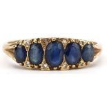 18ct gold sapphire and diamond ring set with five graduated sapphires and eight diamonds, the