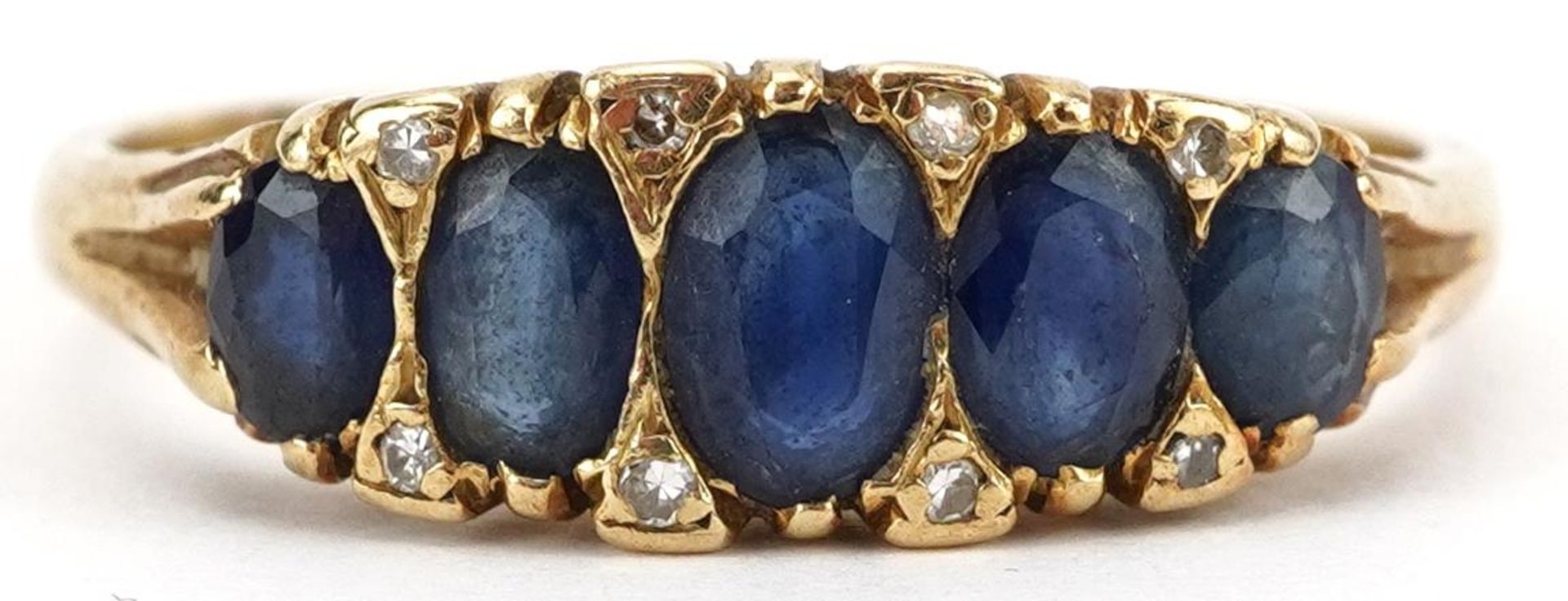 18ct gold sapphire and diamond ring set with five graduated sapphires and eight diamonds, the