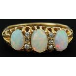Edwardian 18ct gold cabochon opal and diamond ring with ornate pierced setting, set with three opals
