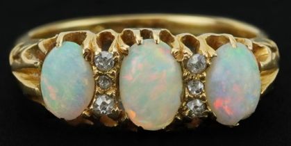 Edwardian 18ct gold cabochon opal and diamond ring with ornate pierced setting, set with three opals