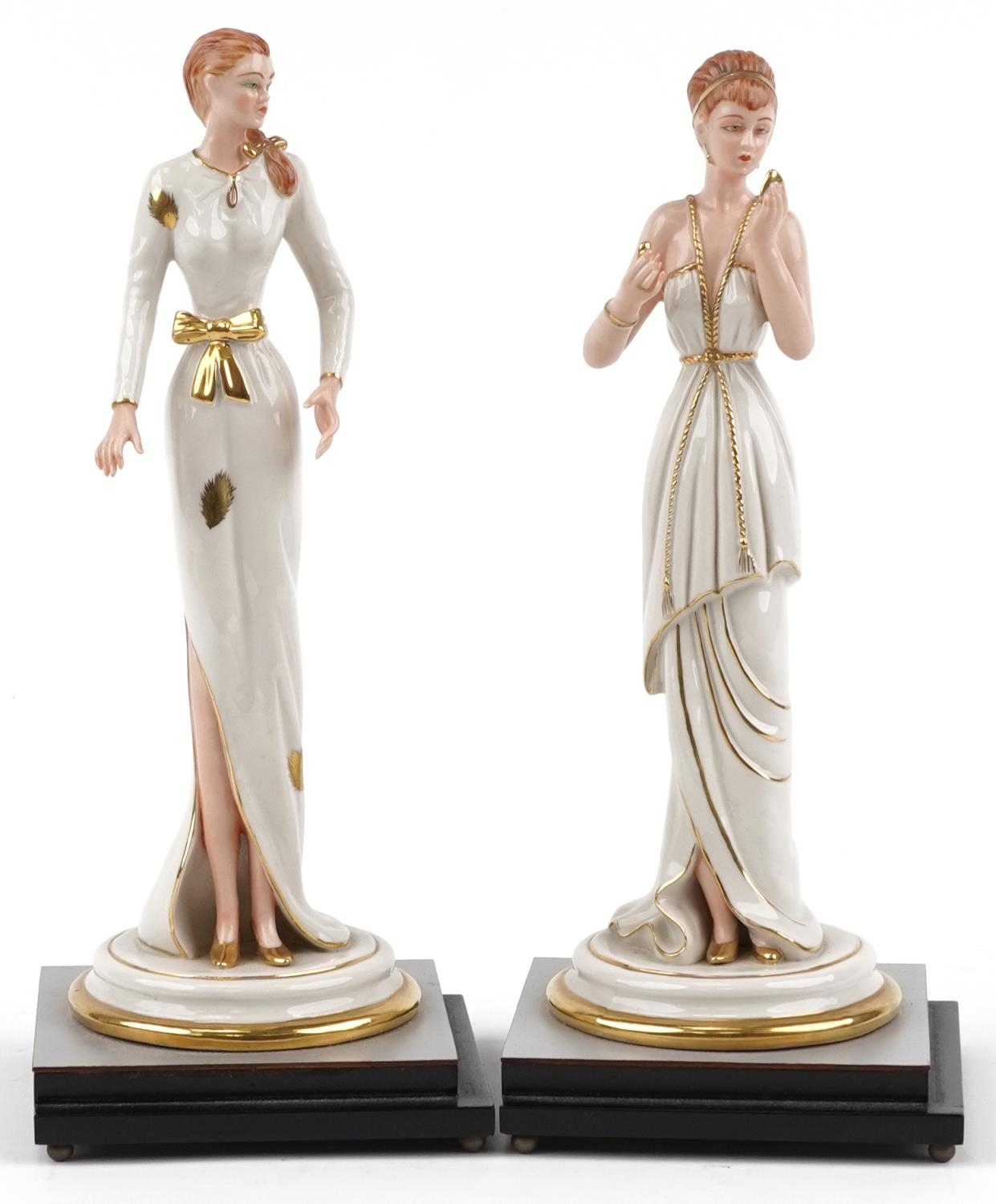 Pair of Italian porcelain figurines of females raised on silvered and ebonised stepped square bases,