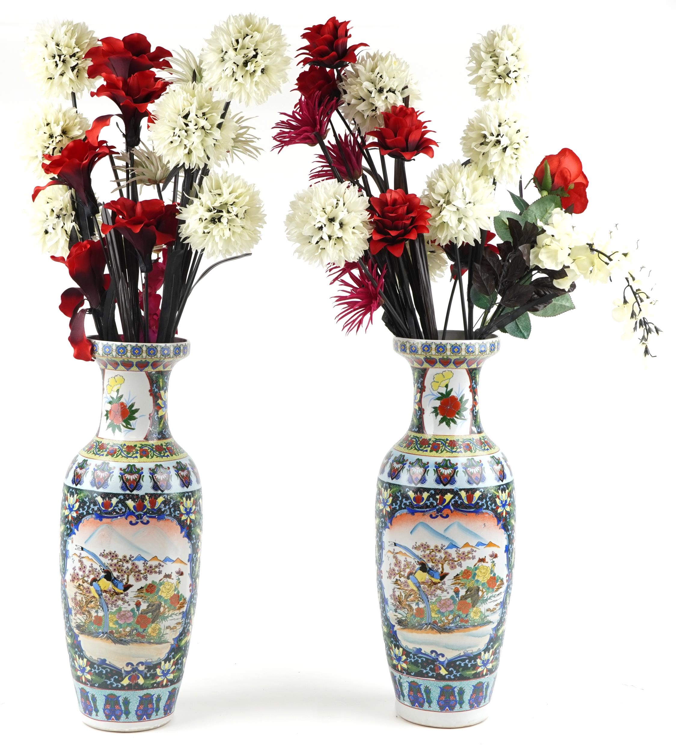 Large pair of Chinese porcelain vases decorated with flowers housing artificial flowers, each vase