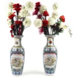 Large pair of Chinese porcelain vases decorated with flowers housing artificial flowers, each vase