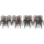 Set of eight antique oak wheel back dining chairs together with two oak wheel back carver chairs,