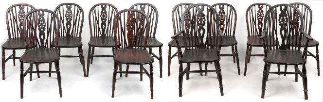 Set of eight antique oak wheel back dining chairs together with two oak wheel back carver chairs,