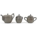 Chinese Swatow Kut Hing pewter three piece tea set comprising teapot, lidded milk jug and lidded