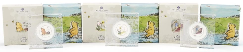 Three Winnie the Pooh silver proof fifty pence pieces by The Royal Mint, housed in Perspex slabs