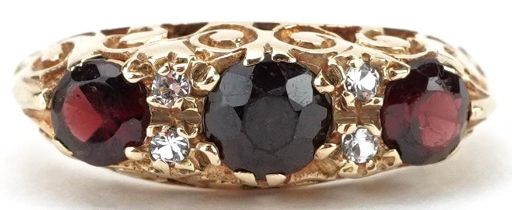 9ct gold garnet and white spinel seven stone ring with ornate pierced setting, size J, 2.5g