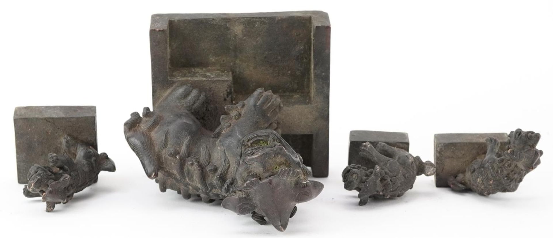 Set of four Chinese patinated bronze interlocking desk seals in the form of qilins, 12cm high - Image 7 of 8