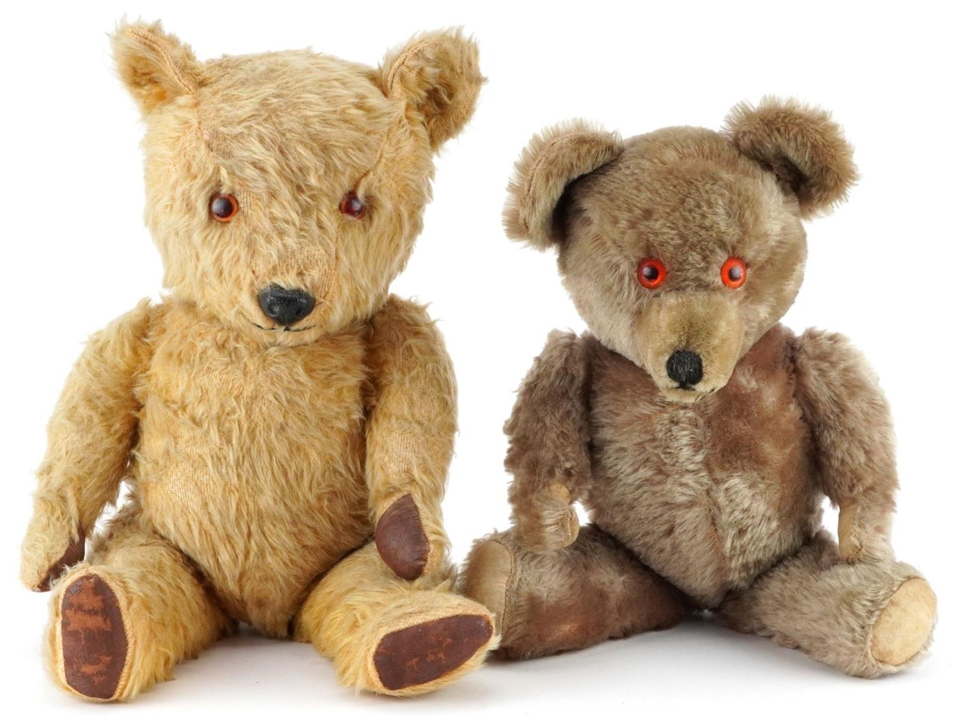 Two early 20th century straw filled teddy bears with jointed limbs including a golden example with