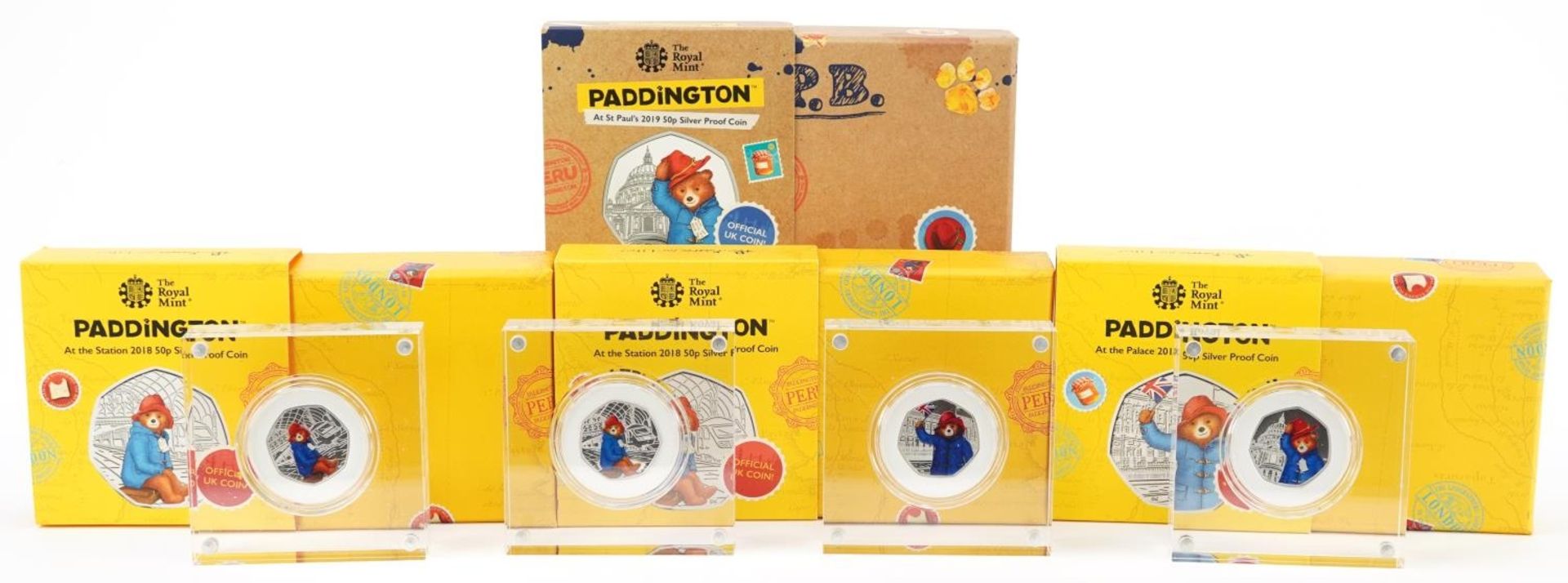 Four Paddington Bear silver proof fifty pence pieces by The Royal Mint, housed in Perspex slabs with