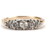 Antique gold graduated diamond five stone ring, the largest diamond approximately 0.20 carat, size