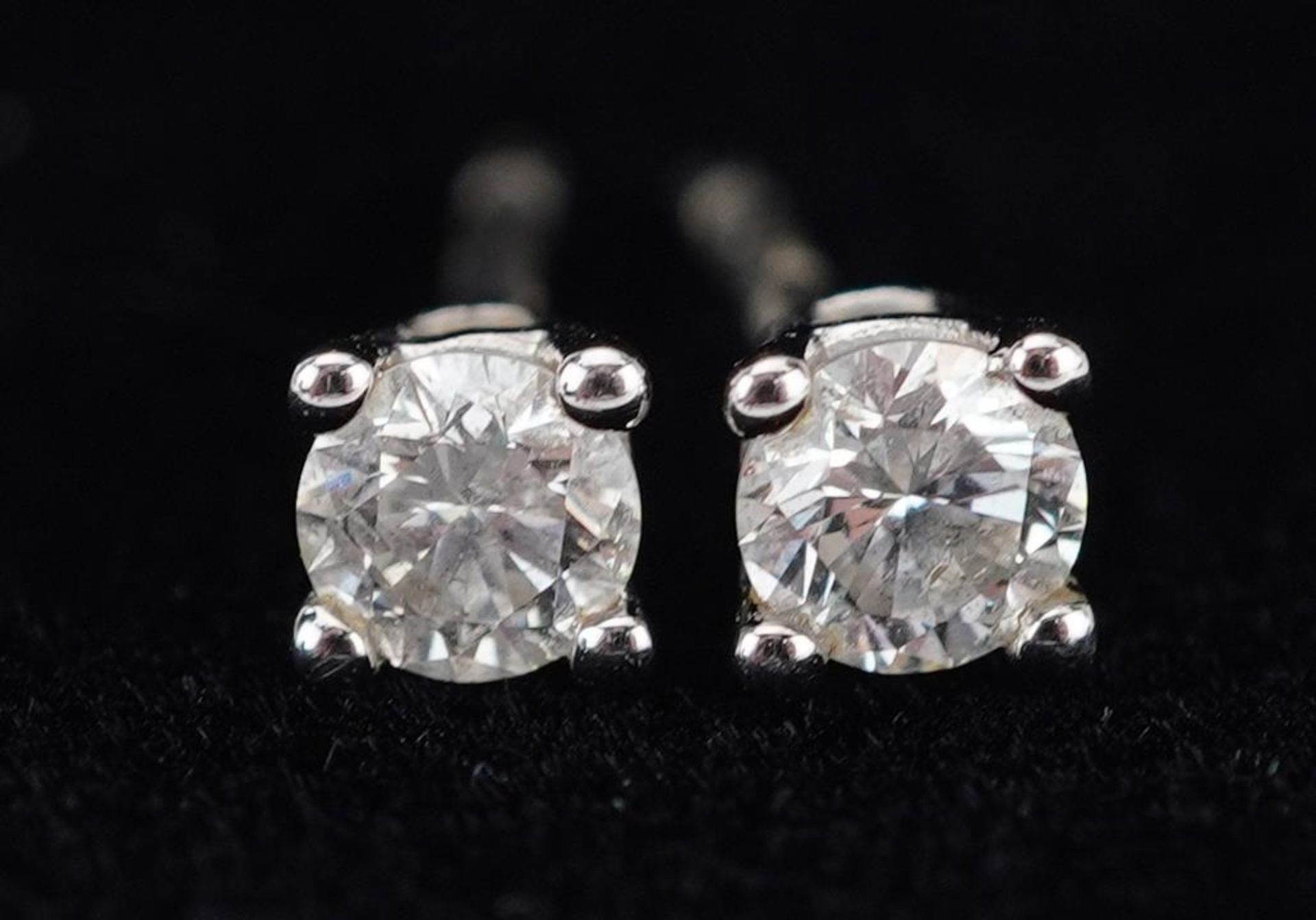 Pair of 9ct white gold diamond solitaire stud earrings with certificate, total diamond weight