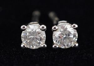 Pair of 9ct white gold diamond solitaire stud earrings with certificate, total diamond weight