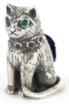 Sterling silver pincushion in the form of a seated cat set with emerald eyes and garnet collar, 2.
