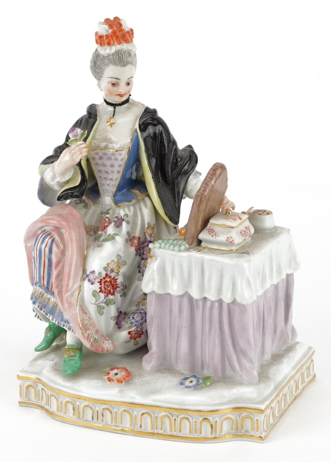 Meissen, 19th century German porcelain figure of a female sitting beside a dressing table with