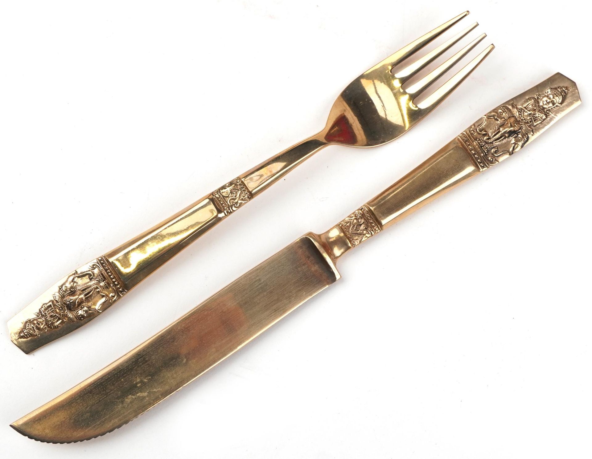 Thai eight place canteen of brass cutlery each with handles cast with deities on elephant back, - Image 5 of 7