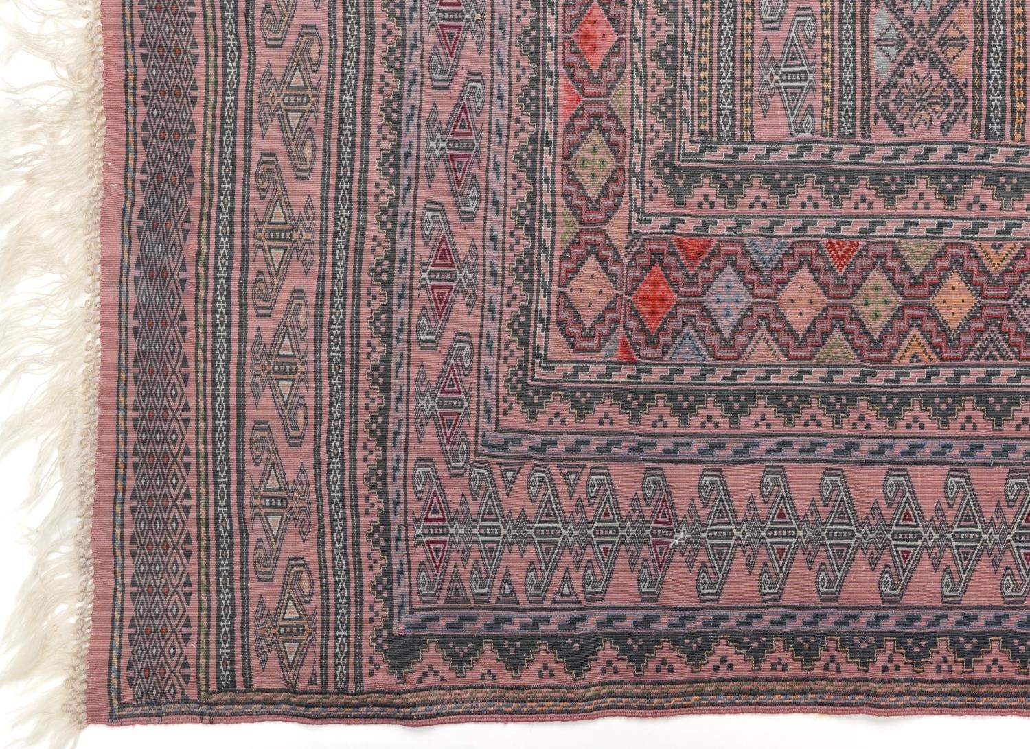 Rectangular Afghan red ground rug having an allover geometric design within corresponding borders, - Image 2 of 4