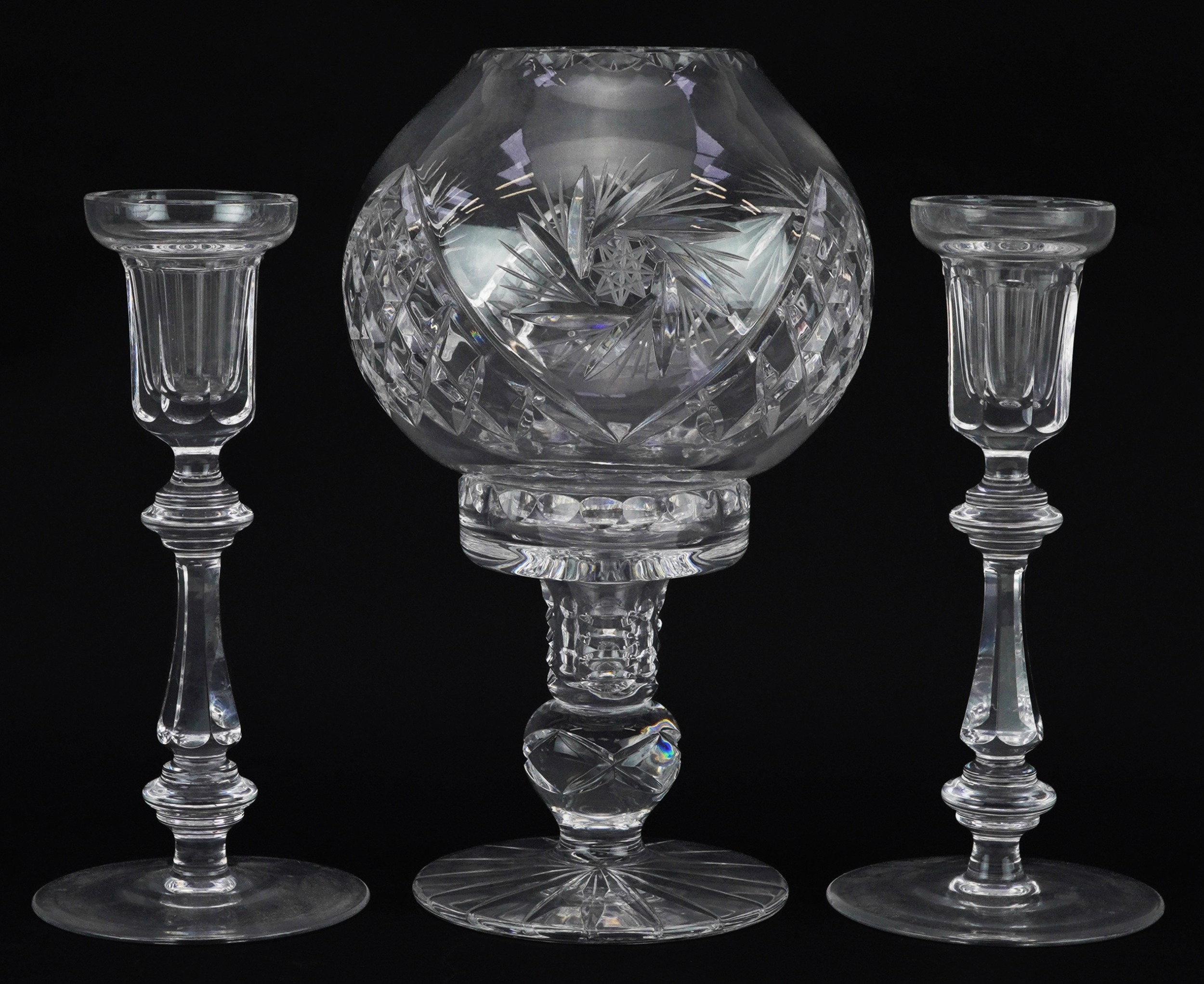 Three cut glass candlesticks comprising one with globular shade and a pair of Curraghmore examples
