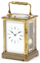 Large French brass cased repeating carriage clock striking on a gong with enamelled dial having