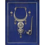Thai white metal jewellery and opium pipe housed in a glazed framed display, overall 55cm x 42.5cm