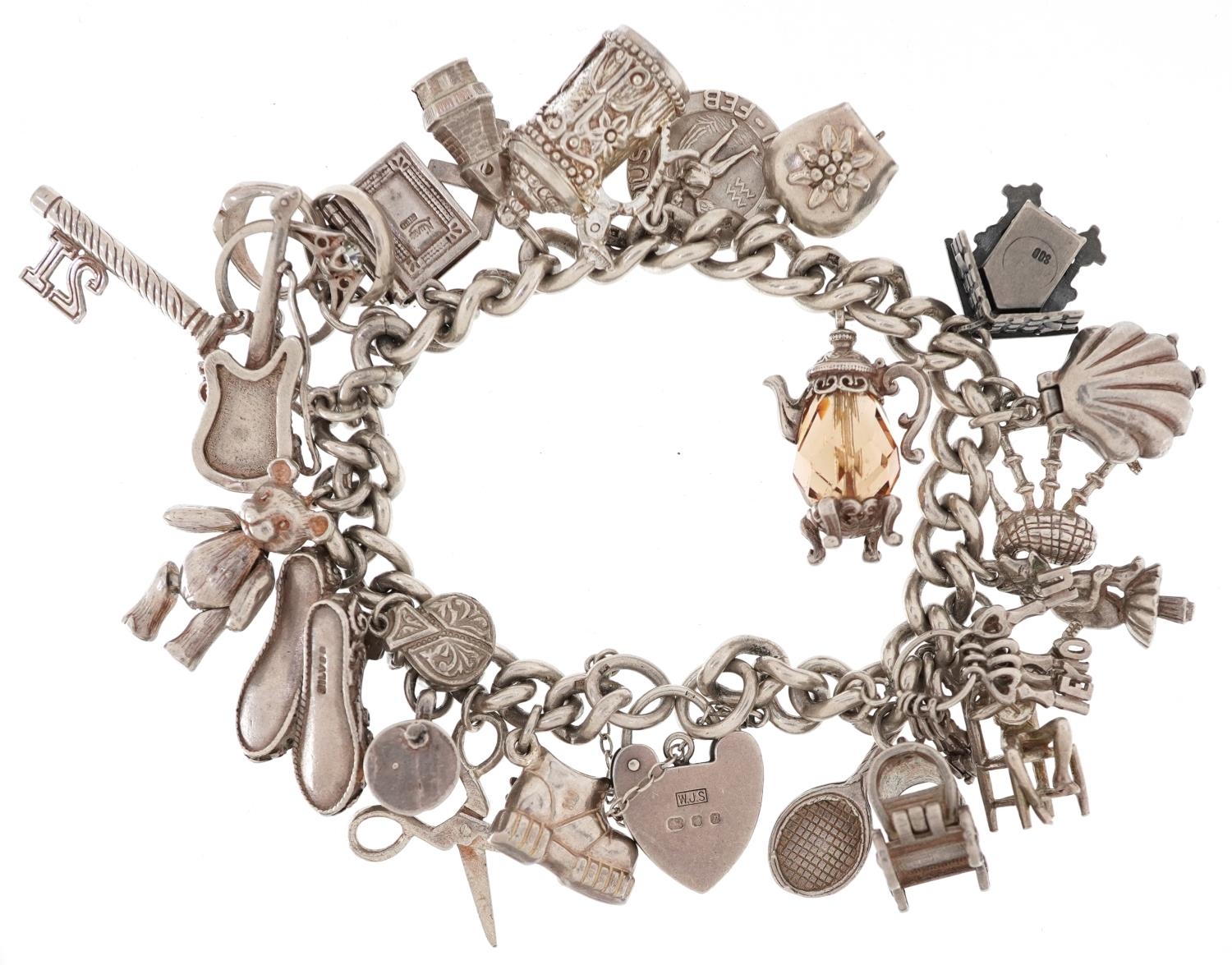 Silver charm bracelet with love heart padlock and a collection of mostly silver charms including - Image 2 of 3