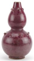 Chinese porcelain double gourd vase having a red glaze, 25cm high