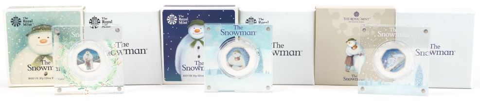 Three The Snowman silver proof fifty pence pieces by The Royal Mint, housed in Perspex slabs with