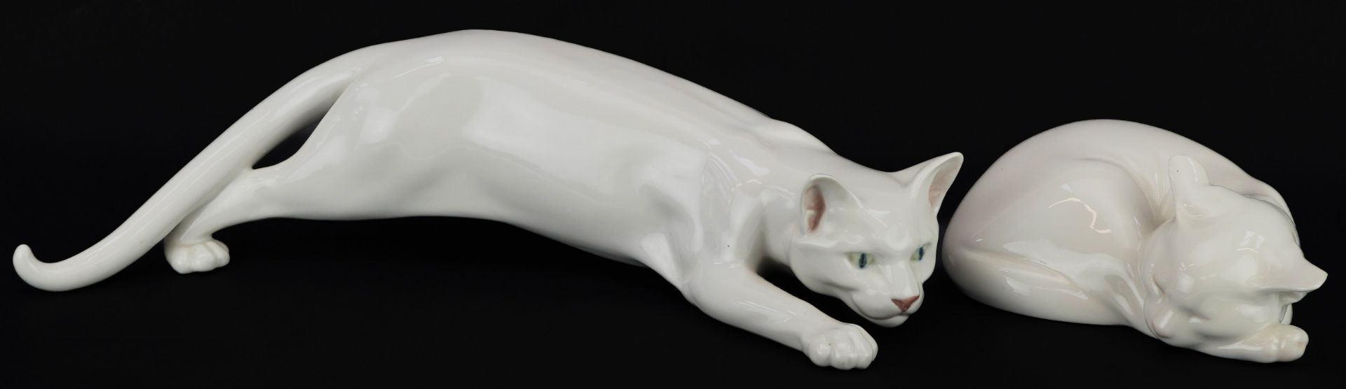 Royal Copenhagen, two Danish porcelain cats including a Stalking Cat by C F Liisberg, the largest