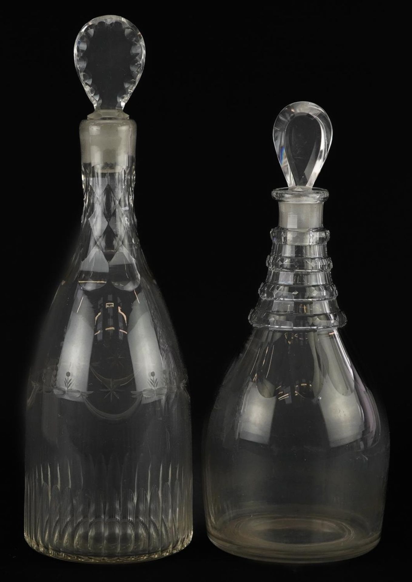 Two Georgian cut glass decanters including one engraved with flowers, the largest 32cm high