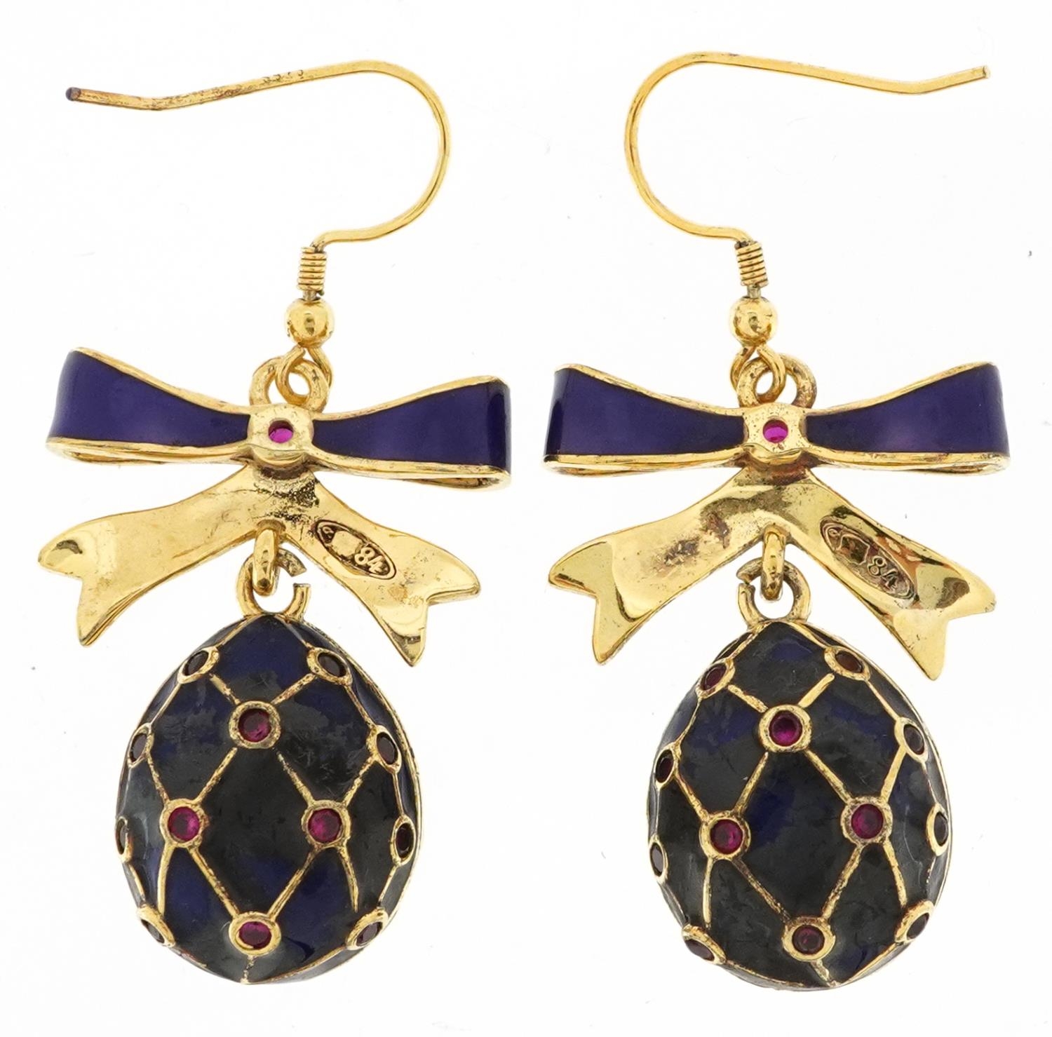 Pair of silver gilt blue enamel and garnet drop earrings in the form of bows with eggs, each set - Image 2 of 3