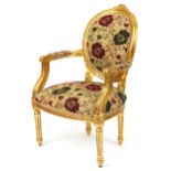 French Baroque style giltwood elbow chair having cream, red and green floral upholstery, 96.5cm high